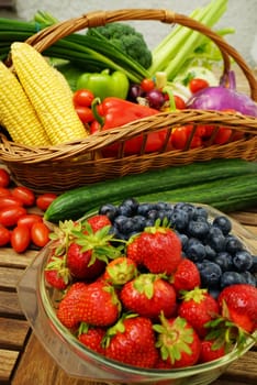 Fresh healthy strawberries and other fruits on a wooden table