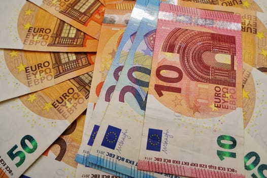 Many different euro banknotes on a white background