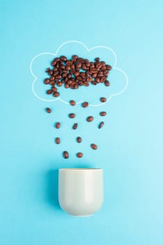 Cloud with roasted coffee beans raining into a cup, take a break, having an espresso for breakfast in the morning, hot drink ingredients on a blue background