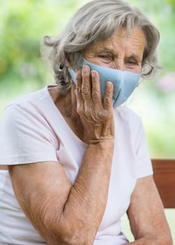 Elderly woman wearing a protective face mask against corona virus