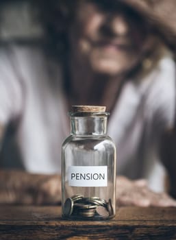 Elderly retired woman and her savings in a jar