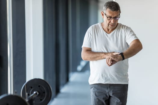 Active and healthy senior exercising in a gym