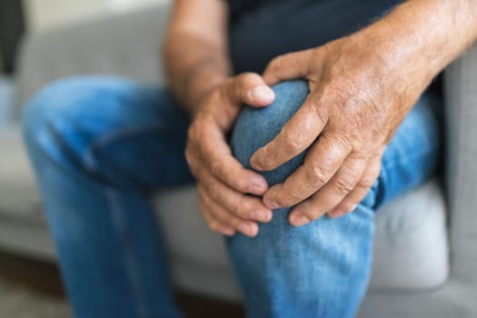 Senior man holding his painful knee