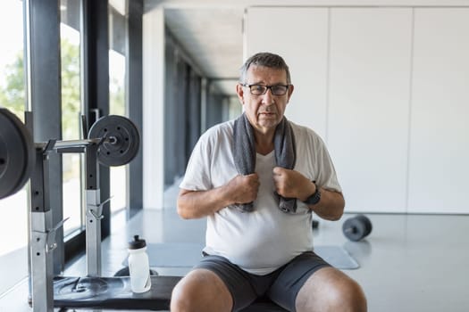 Active and healthy senior exercising in a gym