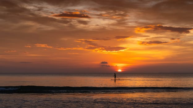 man surfing in the summer sunset