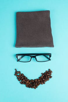 Human face made with a wool hat, glasses and coffee beans as a beard, funny minimalist portrait, eco freak lifestyle, having breakfast, taking a break