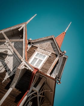 Wooden historical building in Tomsk on the sky background editorial