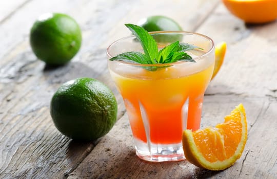 Orange cocktail on rustic wooden table