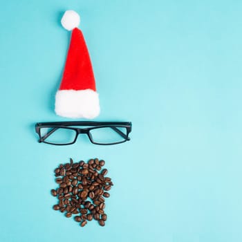 Christmas season, red Santa Claus hat, eyeglasses, beard with coffee beans, funny face, winter time, holiday greeting card, blue background