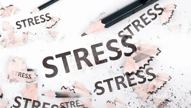 The word stress is standing on a paper, pen with eraser, burnout concept, work life balance, breakdown by exhaustion