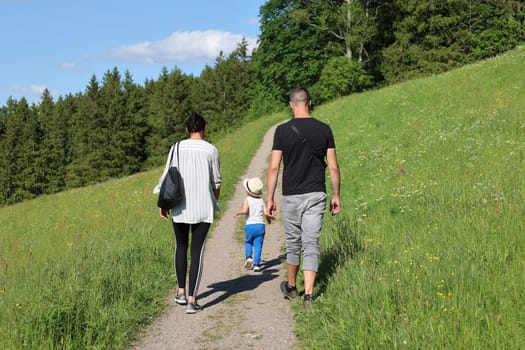 A young family with children enjoys the beauty of nature and the Black Forest landscape during a walk near Hinterzarten (district Breisgau-Hochschwarzwald)