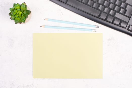 Empty paper with a pen, computer keyboard and a cactus, textured background, brainstorming for new ideas, writing a message, taking a break, home office desk