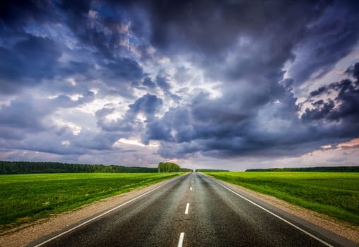 Travel concept background - road and stormy dramatic sky