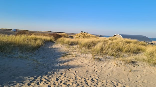 View of the resort of Port Zelande and its surroundings of the lake and dunes under a partly blue sky