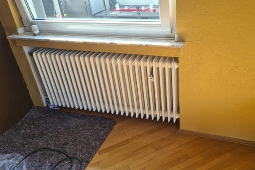 Dismantling a broken radiator in a private house. Radiator.