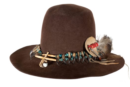 Old Native American hat with hat band made of raptor claws and turquoise on brown felt with eagle feather
