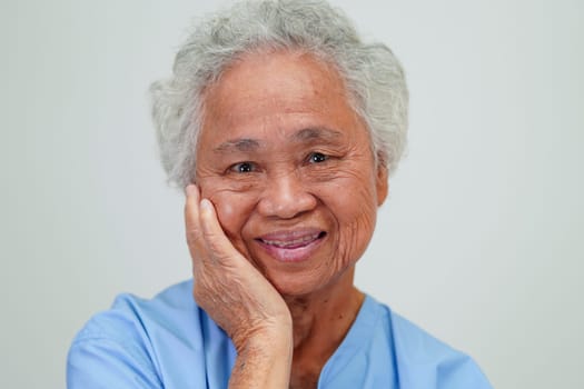 Asian elder senior woman patient sitting and smile face with happy on bed in hospital.