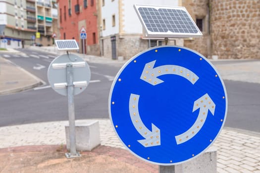 Roundabout sign powered by solar panel. Environmentally friendly traffic signs