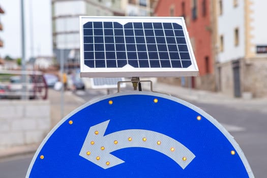 Roundabout sign powered by solar panel. Environmentally friendly traffic signs