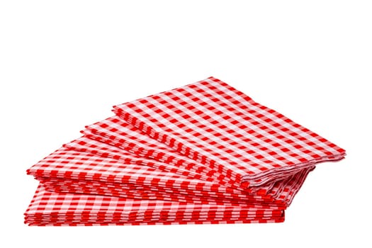 Closeup of a stack of red checked or checkered paper napkins isolated on a white background. Clipping path. Macro. Stacked towel or tablecloth.