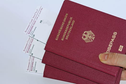 Three German passports and boarding passes for air travel