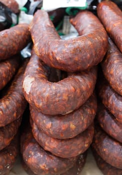 Red iberian chorizo displayed at street market stall. Closeup
