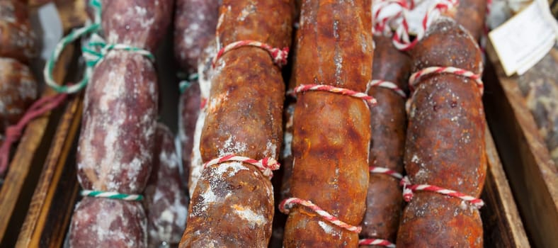 Red and white iberian chorizo displayed at street market stall. Closeup