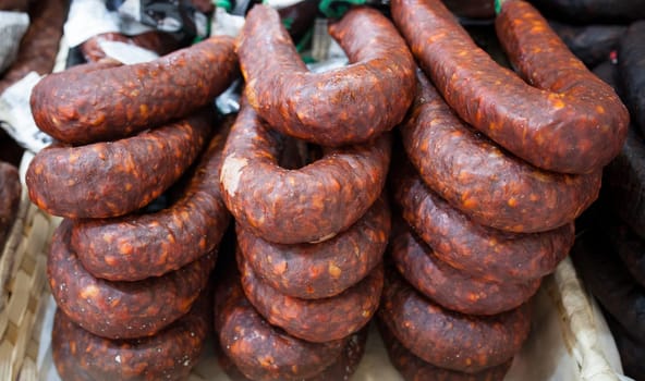 Red iberian chorizo displayed at street market stall. Closeup