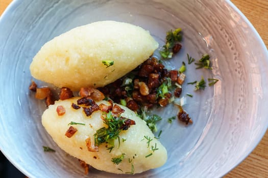 National dish of Lithuania Cepelins or zeppelins - potato dumplings made from grated and riced potatoes and stuffed with ground meat, dry curd cheese or mushrooms.