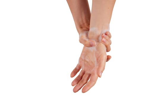 Anonymous woman lathering wrist with soft foam while washing hands during hygienic routine against white background.