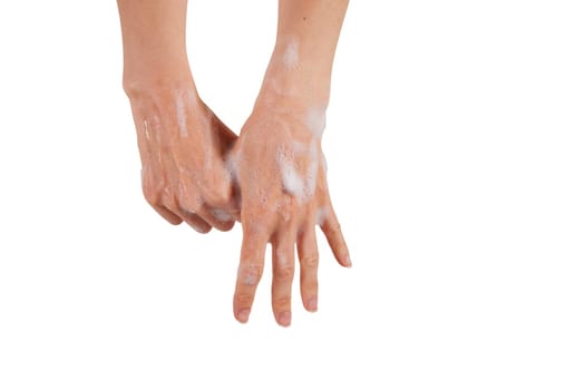 Crop female rubbing foamy thumb while washing hands with antibacterial soap against white background.