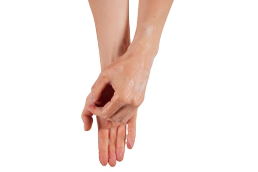 Anonymous woman removing soap from wet hands during hygienic routine against white background