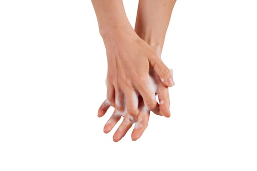 Anonymous female clasping hands and spreading soap foam during hygienic routine against white background