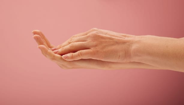 Woman hands on pink background for beauty concepts