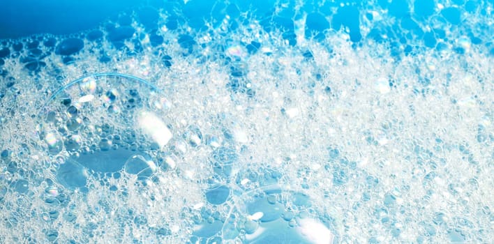 Close up of soap bubbles for laundry detergent, spa or washing powder concepts. Clean symbol macro photography for packaging advertising or wellness or massage stories