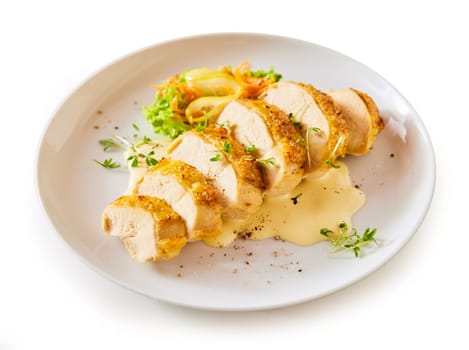 High angle of delicious cut chicken breast served with sauce and vegetable salad on plate on white isolated background