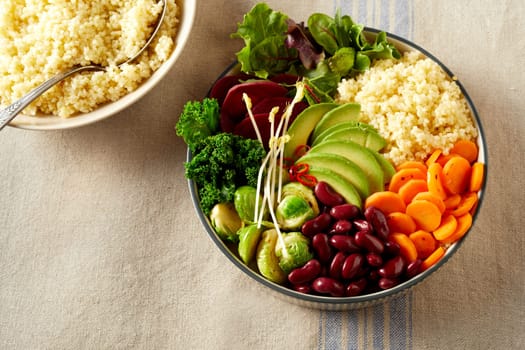 Top view of appetizing fresh vegetables and couscous in bowl placed on table for nourishing lunch at home