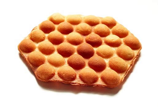 From above of appetizing traditional bubble wafer placed on white background in studio