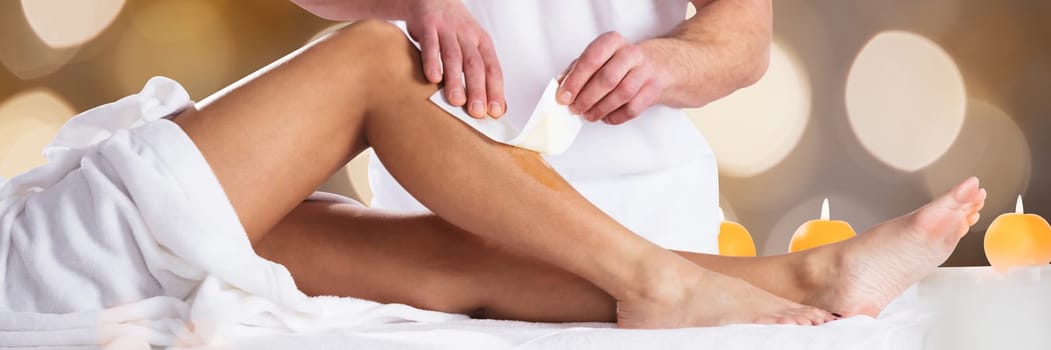 Therapist Waxing Woman's Leg With Wax Strip In Beauty Spa