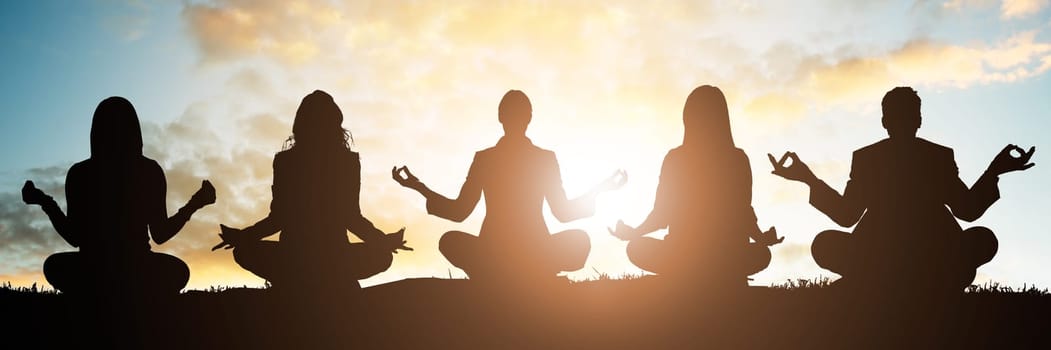 Silhouette Of People Doing Yoga Against Sky During Early Morning