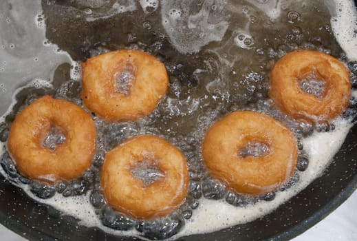 Elaboration process of spanish typical fried donuts or roscas fritas. Overhead view