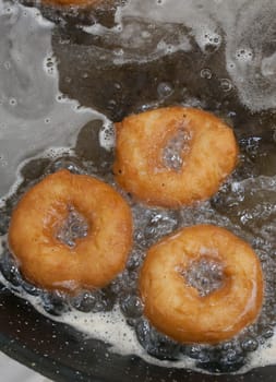 Elaboration process of spanish typical fried donuts or roscas fritas. Overhead view