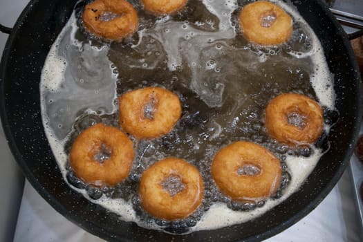 Elaboration process of spanish typical fried donuts or roscas fritas. Overhead view