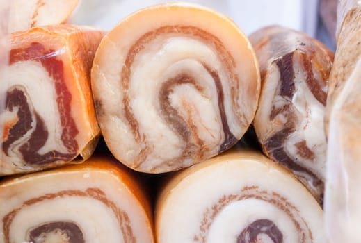 Iberian salt-cured pork fat sausage. Pieces displayed at street market stall