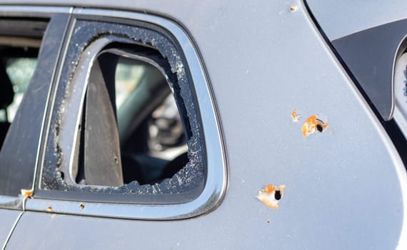 Car riddled with bullets. War of Russia against Ukraine. A car of civilians shot by the Russian military during the evacuation of women and children. Traces of bullets and fragments of shells