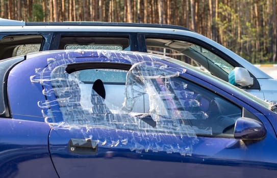 Traces of shots on the body of the car. War between Russia and Ukraine. Part of a civilian car that was fired upon during the evacuation of unarmed people from the combat zone