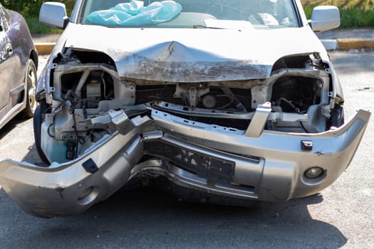 Many broken cars after a traffic accident in the parking lot of a restoration service station on the street. Car body damage workshop outdoors. Sale of insurance emergency vehicles at auction