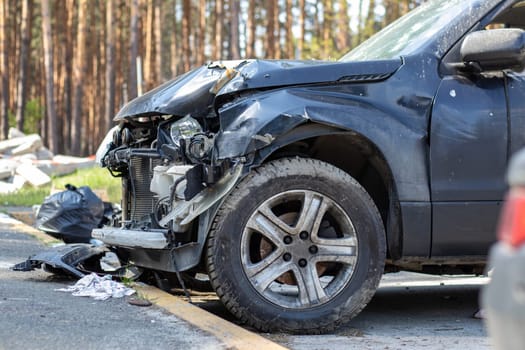 Many broken cars after a traffic accident in the parking lot of a restoration service station on the street. Car body damage workshop outdoors. Sale of insurance emergency vehicles at auction