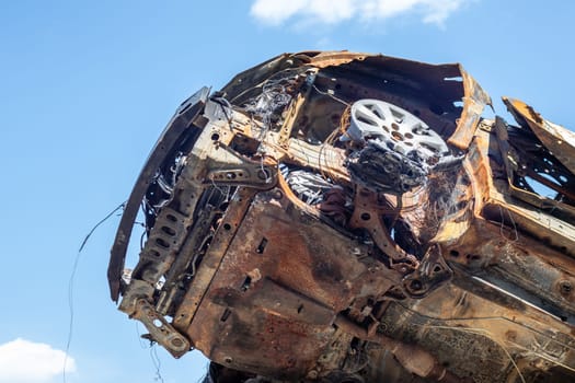 Broken and burned cars in the parking lot, accident or deliberate vandalism. Burnt car. Consequences of a car accident. Damaged by arson. Dump of civilian vehicles shot by Russian troops in Ukraine
