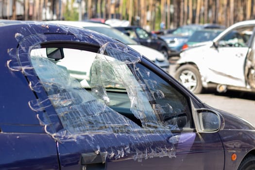 Traces of shots on the body of the car. War between Russia and Ukraine. Part of a civilian car that was fired upon during the evacuation of unarmed people from the combat zone